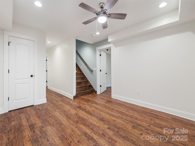 unfurnished room with ceiling fan and dark wood-type flooring