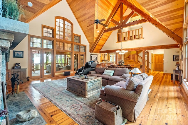 living room with beam ceiling, light hardwood / wood-style flooring, high vaulted ceiling, wooden ceiling, and ceiling fan with notable chandelier