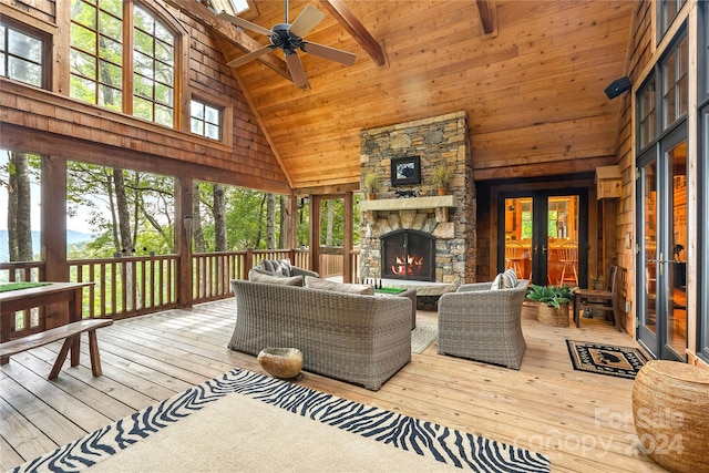 wooden terrace featuring an outdoor living space with a fireplace, ceiling fan, and french doors