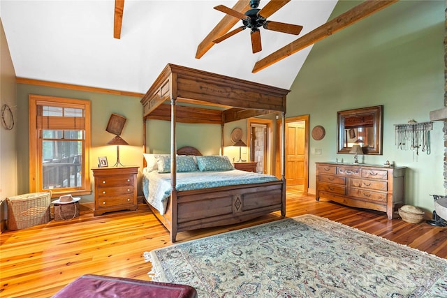 bedroom with ceiling fan, hardwood / wood-style flooring, and beam ceiling