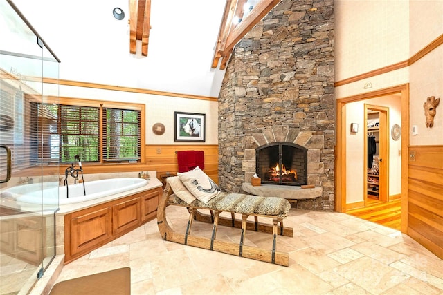 bathroom featuring a stone fireplace, plus walk in shower, beam ceiling, and high vaulted ceiling