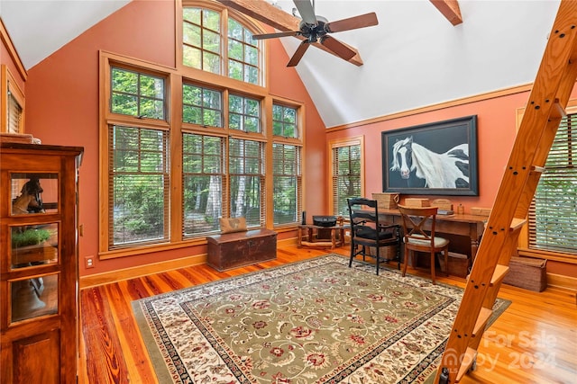 office with wood-type flooring, ceiling fan, and high vaulted ceiling