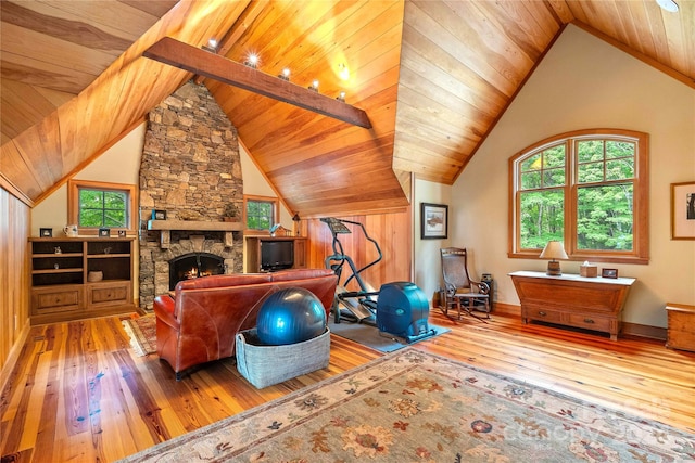 workout room featuring wood-type flooring, a fireplace, wooden ceiling, and a healthy amount of sunlight