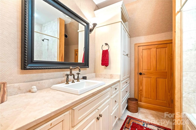 bathroom featuring walk in shower, vanity, and tile patterned flooring