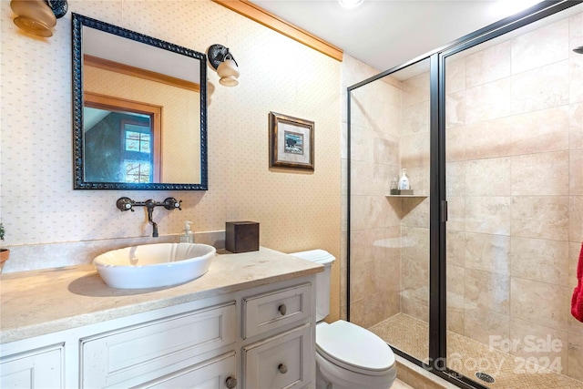 bathroom featuring vanity, toilet, and a shower with door