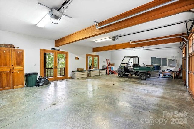 garage with a garage door opener and electric panel