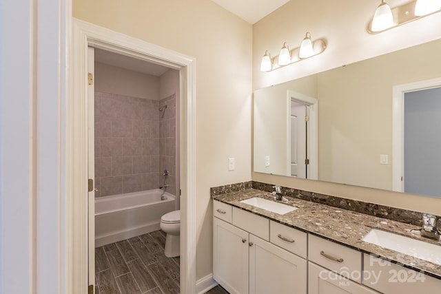 full bathroom featuring vanity, toilet, and tiled shower / bath combo