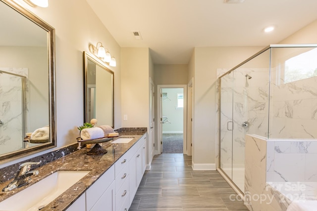 bathroom with vanity and a shower with shower door