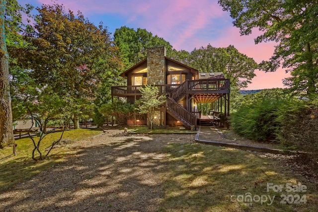 exterior space with a wooden deck and a lawn