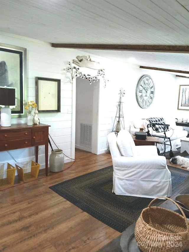 living room featuring lofted ceiling with beams and hardwood / wood-style flooring