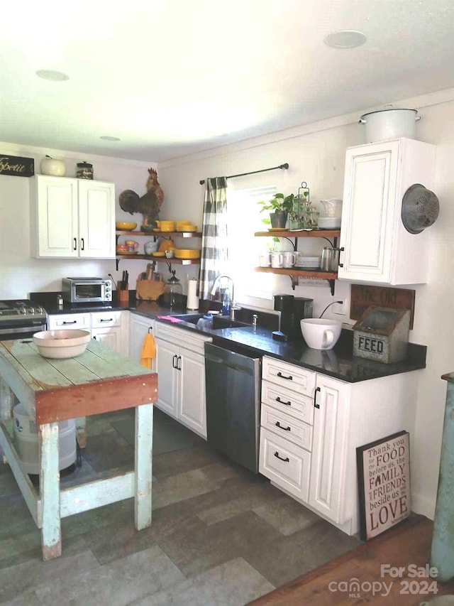 kitchen featuring electric range, dishwasher, white cabinetry, and sink