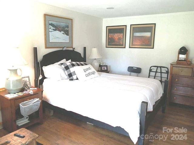 bedroom with dark wood-type flooring