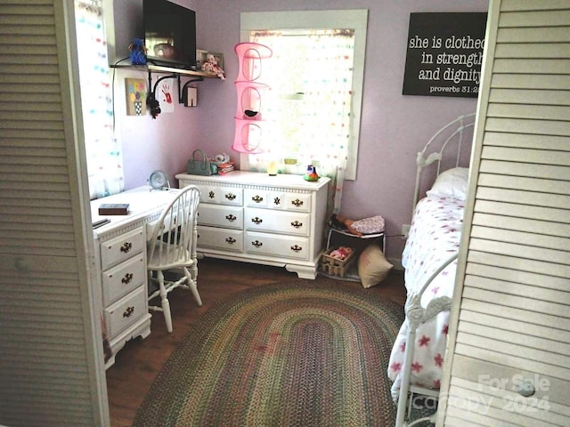 bedroom with dark wood-type flooring