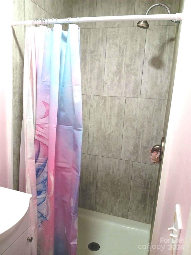 bathroom featuring vanity and curtained shower