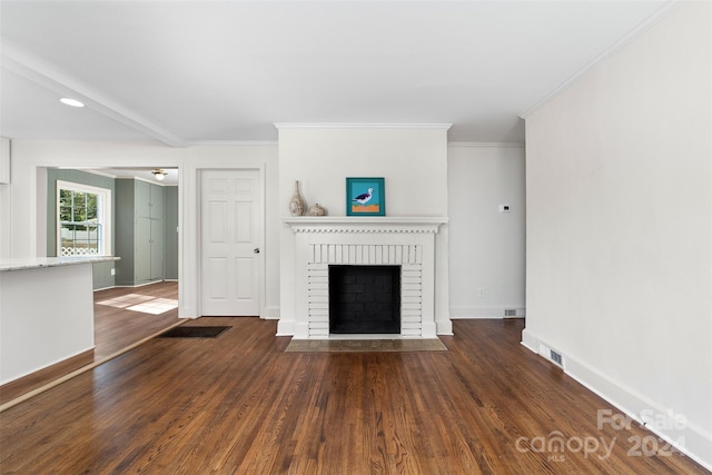 unfurnished living room featuring a fireplace, dark hardwood / wood-style floors, and ornamental molding