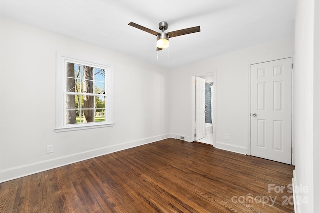 unfurnished room with ceiling fan and dark hardwood / wood-style flooring