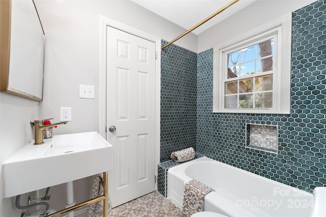 full bathroom featuring toilet, sink, and tiled shower / bath