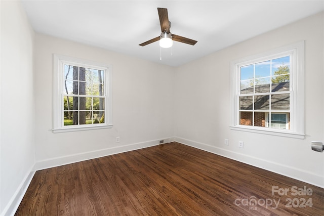 empty room with a healthy amount of sunlight, wood-type flooring, and ceiling fan