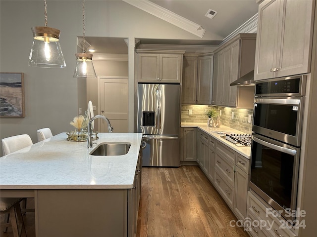 kitchen with sink, appliances with stainless steel finishes, a kitchen breakfast bar, and crown molding