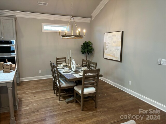 dining area with crown molding and dark hardwood / wood-style floors