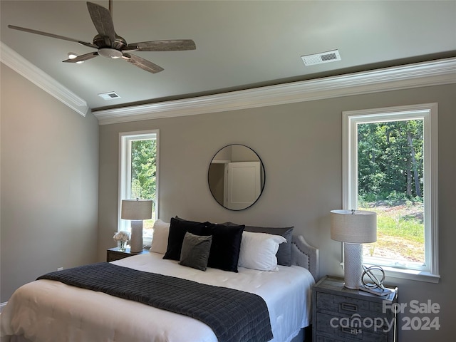 bedroom featuring crown molding, vaulted ceiling, multiple windows, and ceiling fan