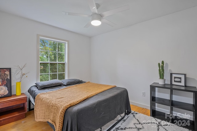 bedroom with ceiling fan and light wood-type flooring