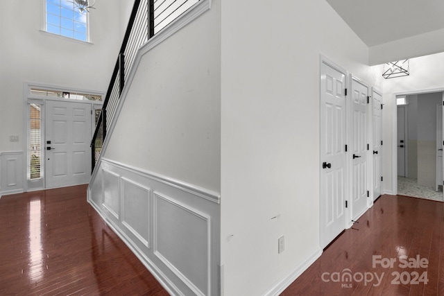 entryway with a high ceiling and dark hardwood / wood-style flooring