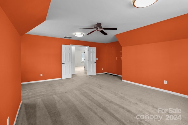 bonus room featuring ceiling fan and carpet