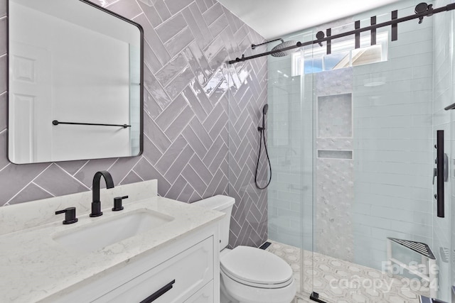 bathroom featuring tasteful backsplash, walk in shower, vanity, tile walls, and toilet