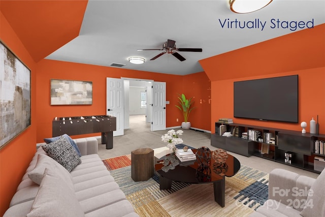 living room with ceiling fan and light colored carpet