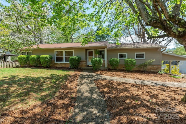 single story home with a front lawn and a carport