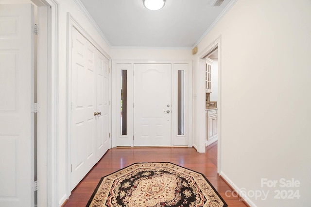 foyer entrance featuring dark hardwood / wood-style floors and crown molding