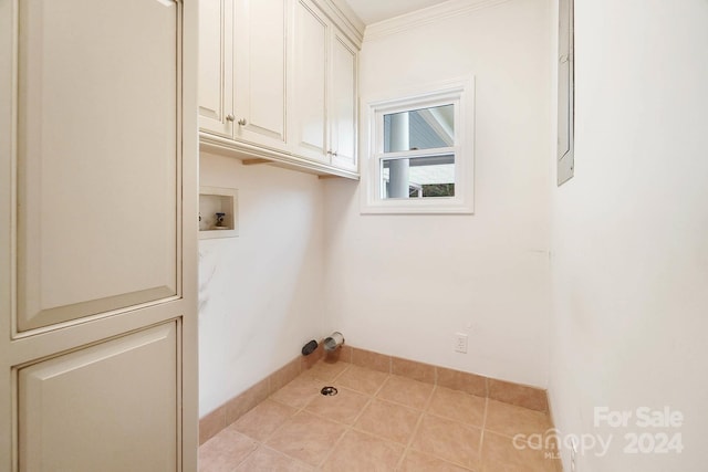 laundry room featuring washer hookup, light tile patterned floors, cabinets, and ornamental molding