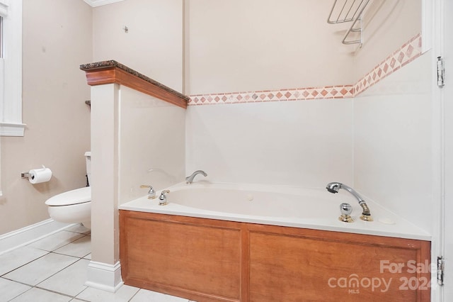 bathroom featuring a washtub, toilet, and tile patterned floors