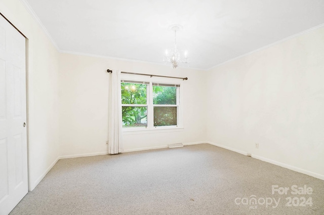 unfurnished room featuring an inviting chandelier, crown molding, and carpet