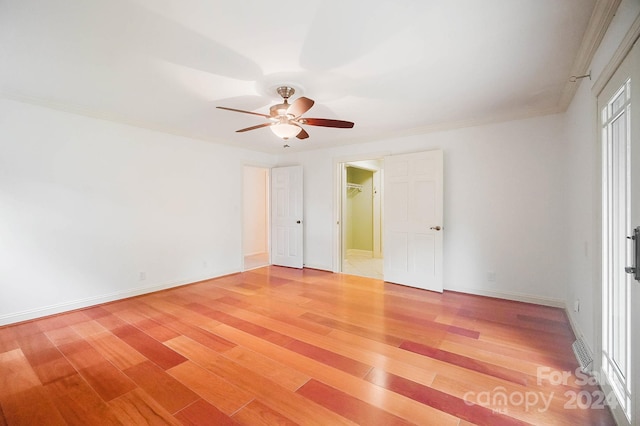 interior space with ceiling fan, hardwood / wood-style flooring, and crown molding