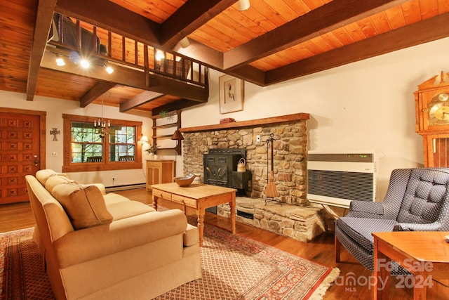 living room with baseboard heating, a wood stove, hardwood / wood-style floors, and wood ceiling