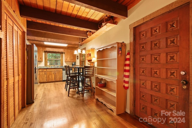 interior space with beam ceiling, light wood-type flooring, sink, and wooden ceiling