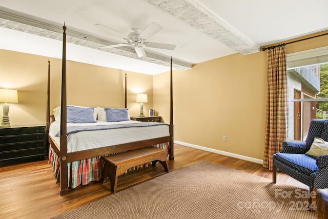 bedroom featuring ceiling fan, beamed ceiling, and hardwood / wood-style flooring