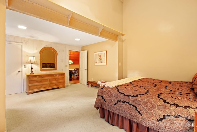 bedroom featuring carpet flooring and wood walls