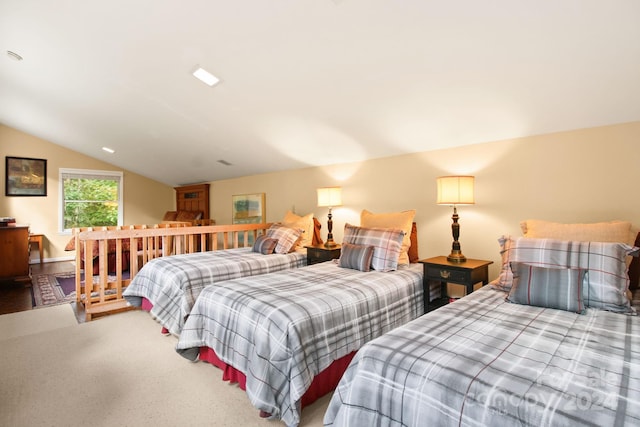 bedroom featuring carpet and vaulted ceiling