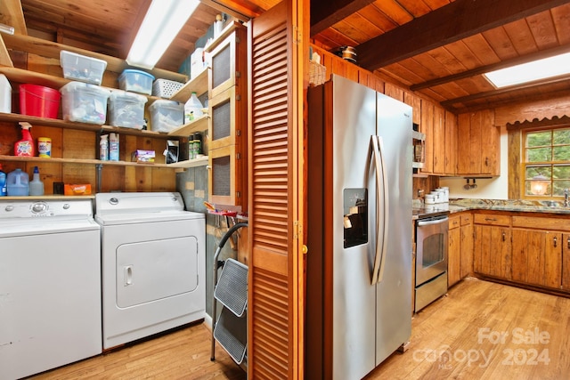 washroom featuring wood ceiling, washer and clothes dryer, light hardwood / wood-style floors, and sink