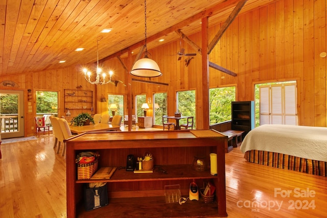 interior space with a chandelier, wooden walls, wood ceiling, and light wood-type flooring