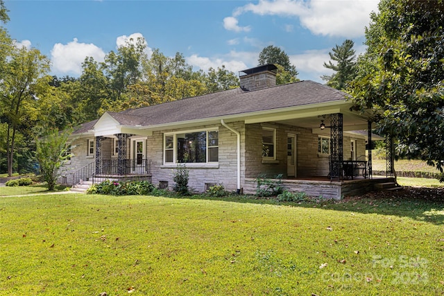 single story home with a front yard and covered porch