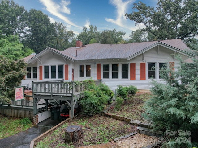 ranch-style home with a wooden deck