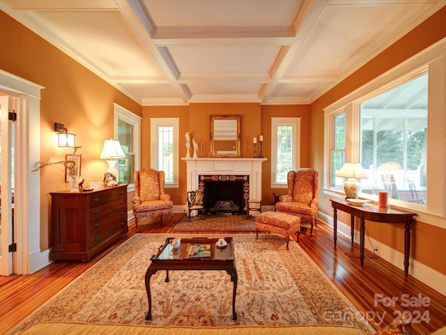 living room with wood-type flooring, coffered ceiling, beamed ceiling, and a premium fireplace