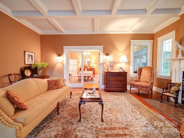 living room with ornamental molding, beamed ceiling, hardwood / wood-style flooring, and coffered ceiling