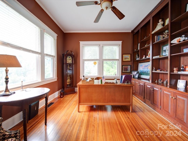 office area featuring ceiling fan, ornamental molding, and light hardwood / wood-style floors