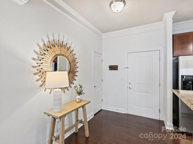 foyer entrance featuring crown molding and dark wood-type flooring