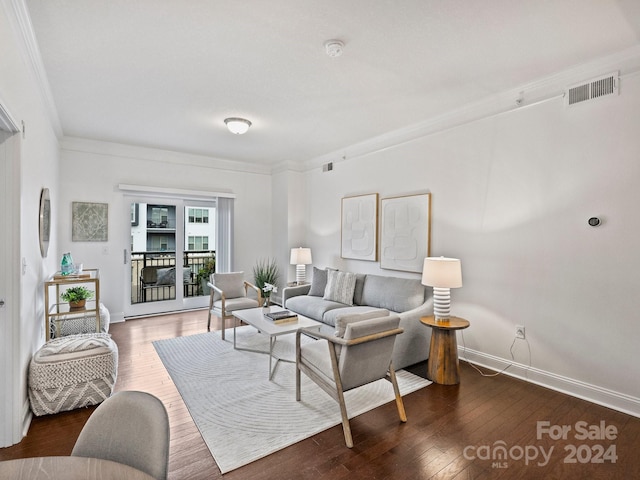 living room featuring crown molding and dark hardwood / wood-style flooring